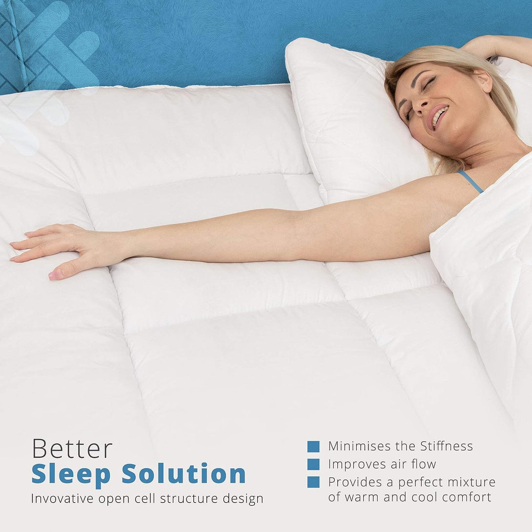 A woman relaxes on the BRIT DIAMOND Extra Deep Mattress Topper (10cm thick), smiling with eyes closed. Text highlights its hypoallergenic, innovative design for reduced stiffness, better airflow, and balanced warm and cool comfort.