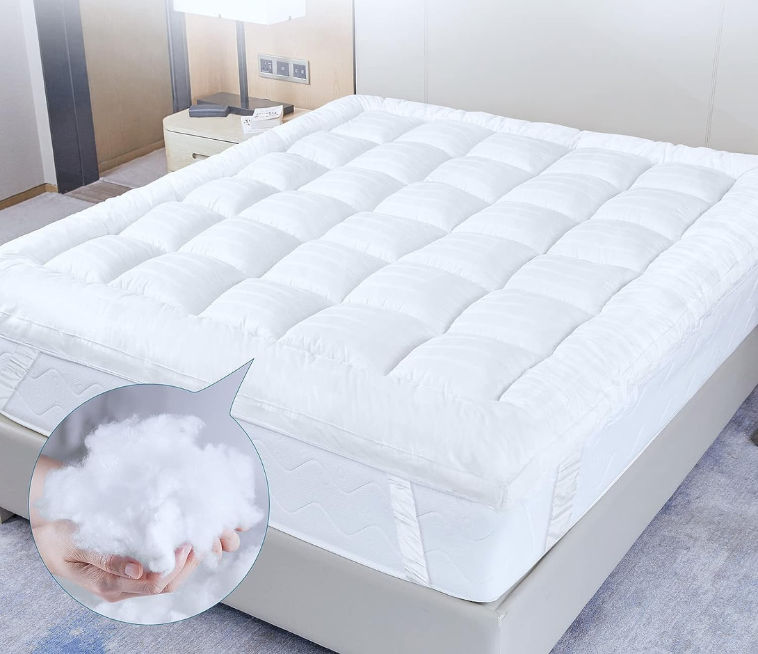 The BRIT DIAMOND Extra Deep Mattress Topper (10cm thick) is shown on a bed, highlighting its quilted, fluffy comfort and hypoallergenic filling. An inset displays a hand holding the soft topper material. Available in Single to Super King.