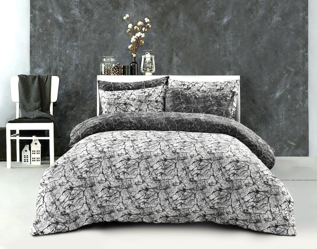 A modern bedroom features the BRIT DIAMOND Reversible Duvet Cover Set, a 100% cotton 200TC printed bedding set in Double & Super King sizes, paired with a white chair, decorative jars, and cotton branches for minimalist decor.