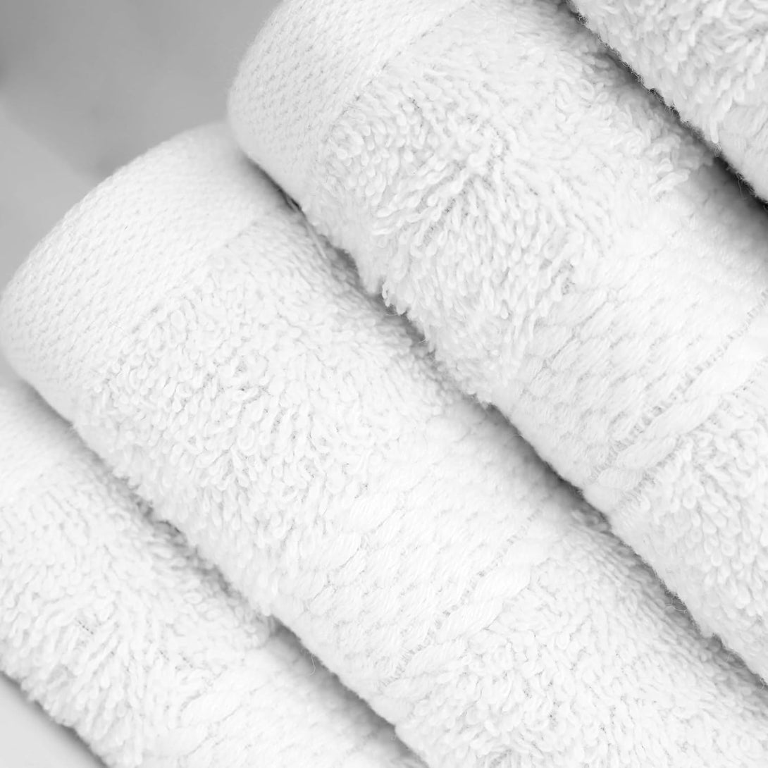 Four soft, fluffy BRIT DIAMOND 100% cotton bath towels from the Bath Towels Pack of 2 or 4 are neatly rolled side by side, highlighting their absorbency, quick-dry fabric, and subtle edge patterns in multiple colours.