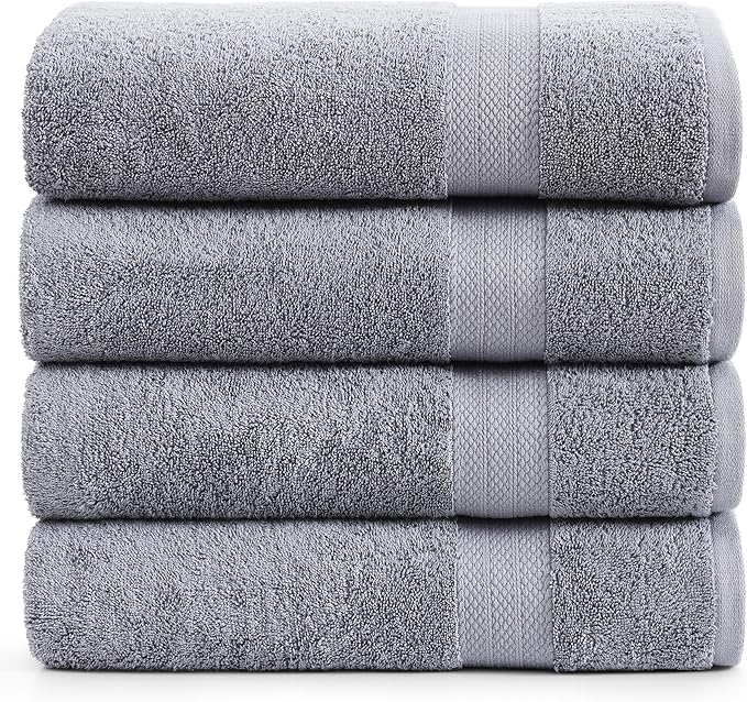 Four plush, quick-drying BRIT DIAMOND bath sheets—made from 100% cotton—are stacked neatly, each featuring a textured band. Sold in packs of 2 or 4, these large towels are soft, absorbent, and available in multiple colours.