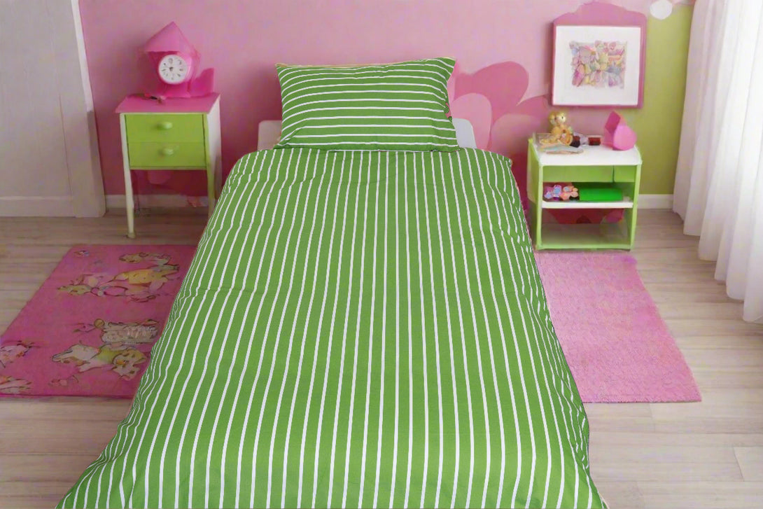 A neatly made single bed with the BRIT DIAMOND Kids Tangled Pascal Pink Rotary Reversible Duvet Cover Set brings playful princess charm to a pink and green bedroom with nightstands, clock, lamps, pink rugs, and wall art.