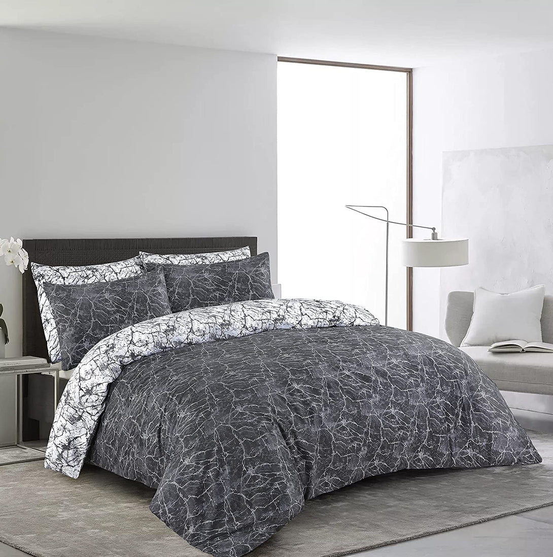 Modern bedroom with a BRIT DIAMOND Reversible Duvet Cover Set (100% Cotton, 200TC, Double & Super King), featuring a dark gray marble print and matching pillows. A large window, white floor lamp, gray couch, and minimalist décor complete the look.