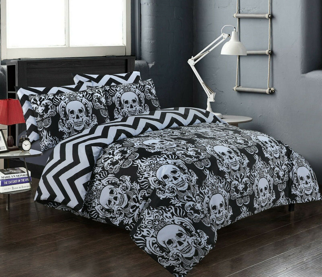 A modern room with dark walls features the BRIT DIAMOND Reversible Duvet Cover Set (100% Cotton, 200TC) in black and white skull print, plus chevron pillows, a white desk lamp, and a red bedside lamp.