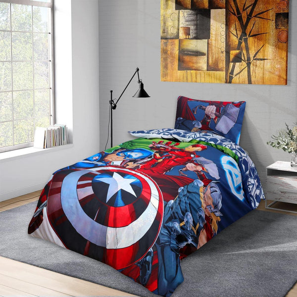 A twin bed features the BRIT DIAMOND Marvel Avengers Reversible Duvet Cover Set—action-packed superhero bedding with Captain America, Iron Man, Thor, and Hulk—in a bright room with a large window, abstract art, and nightstand with plant and books.