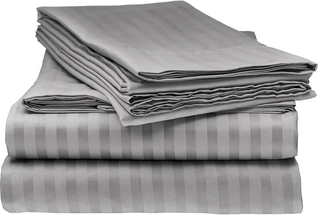 A neatly stacked BRIT DIAMOND Luxury 400 Thread Count Satin Stripe Bedding Duvet Set, made from 100% Egyptian cotton, including quilt covers and pillowcases, displayed against a white background.