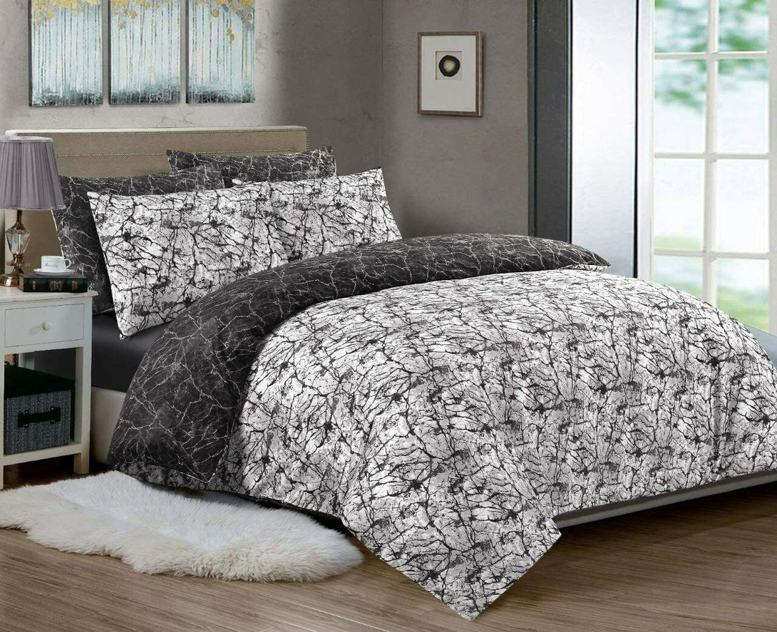 A modern bedroom features a BRIT DIAMOND Reversible Duvet Cover Set—100% cotton, 200TC, marble-patterned—paired with a nightstand, lamp, white rug, and large windows streaming natural light.