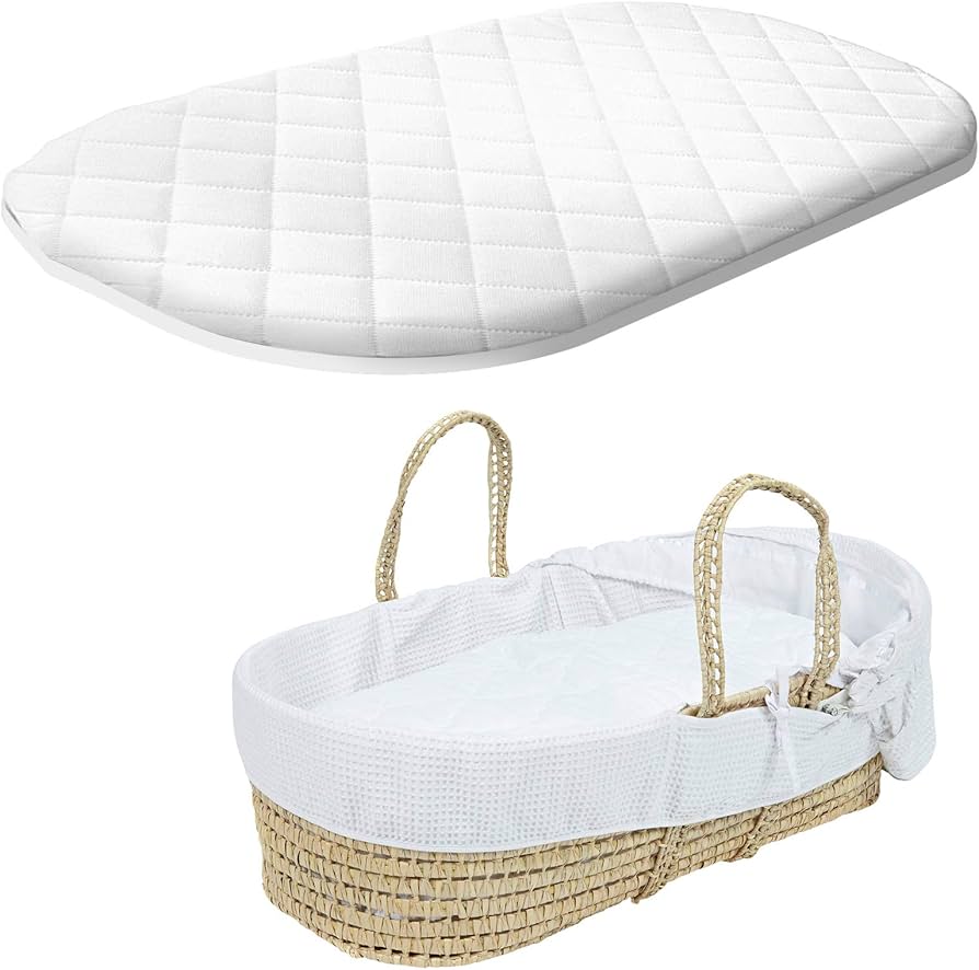 A BRIT DIAMOND Premium Baby Moses Basket Foam Mattress, soft and breathable for newborns, rests above a woven Moses basket with a hypoallergenic cover and two handles. The basket is empty and matches the white quilted oval mattress.