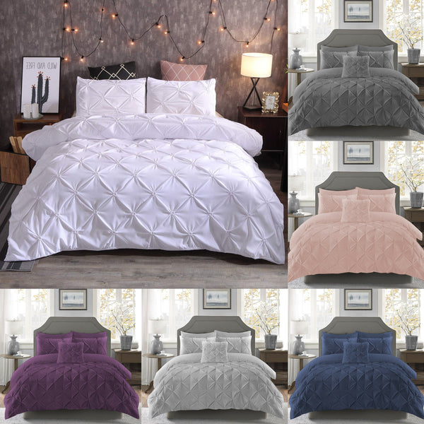 The BRIT DIAMOND Pintuck Duvet Set, made of 100% Egyptian cotton, is displayed in white on a cozy bed, with alternate color options—gray, blush pink, purple, light gray, and navy—shown on the side and bottom of the image.