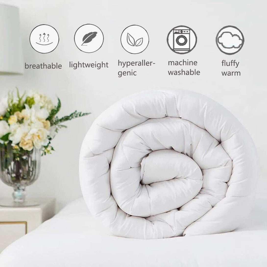 A rolled-up white BRIT DIAMOND Premium Hotel Quality Duvet Deep Sleep Quilt is on a bed, with icons showing it’s breathable, lightweight, hypoallergenic, machine washable, fluffy, and warm. A vase and nightstand are seen behind. Available in all UK sizes and togs.