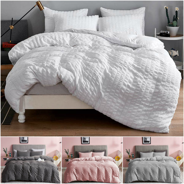 A collage of four BRIT DIAMOND Seersucker Duvet Cover Quilt Sets in white, gray, pink, and dark gray—each 100% Egyptian cotton with matching pillows in modern bedrooms. Free UK delivery on these bedding sets (Double, King, Super King).